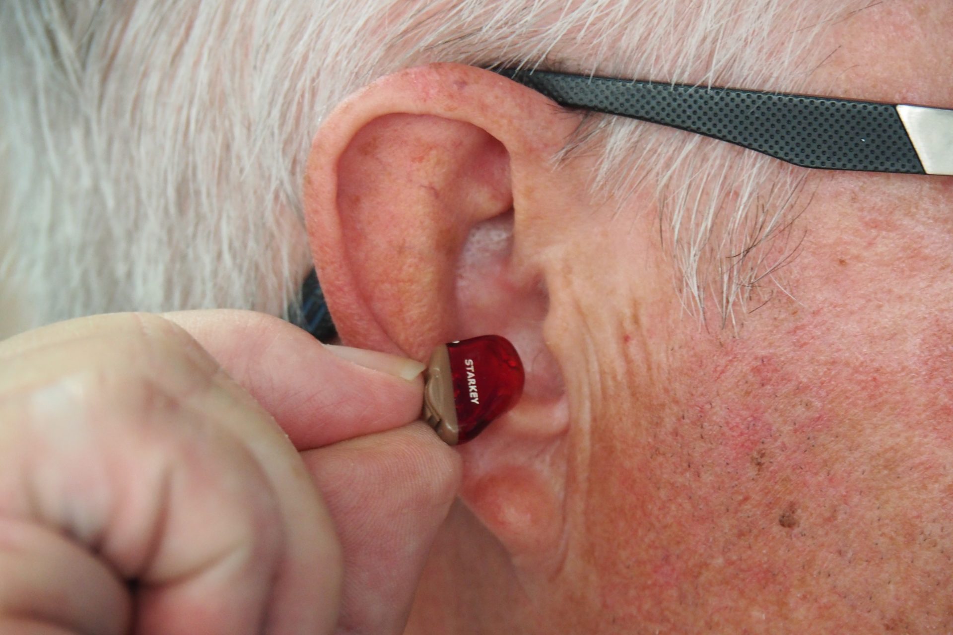 elderly person wearing hearing aid
