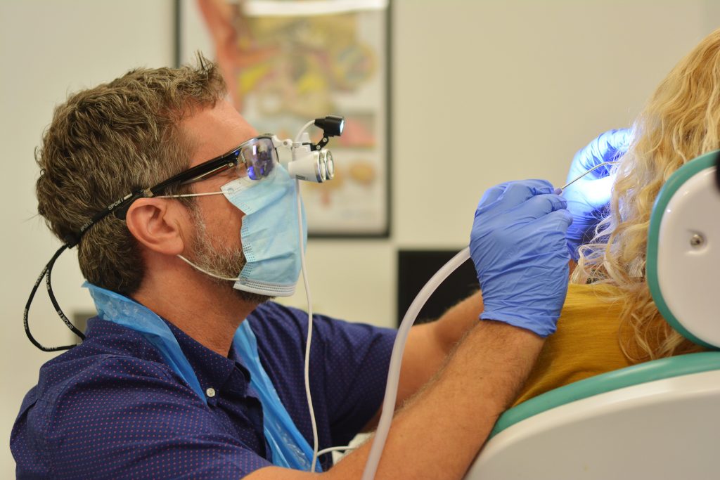 man doing earwax removal procedure
