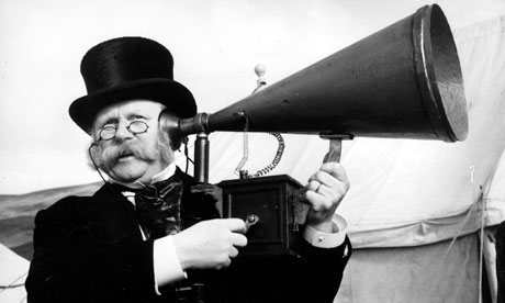 man ear trumpet hearing aid up to ear to improve his hearing