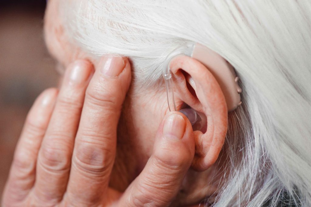 elderly woman wearing hearing aid