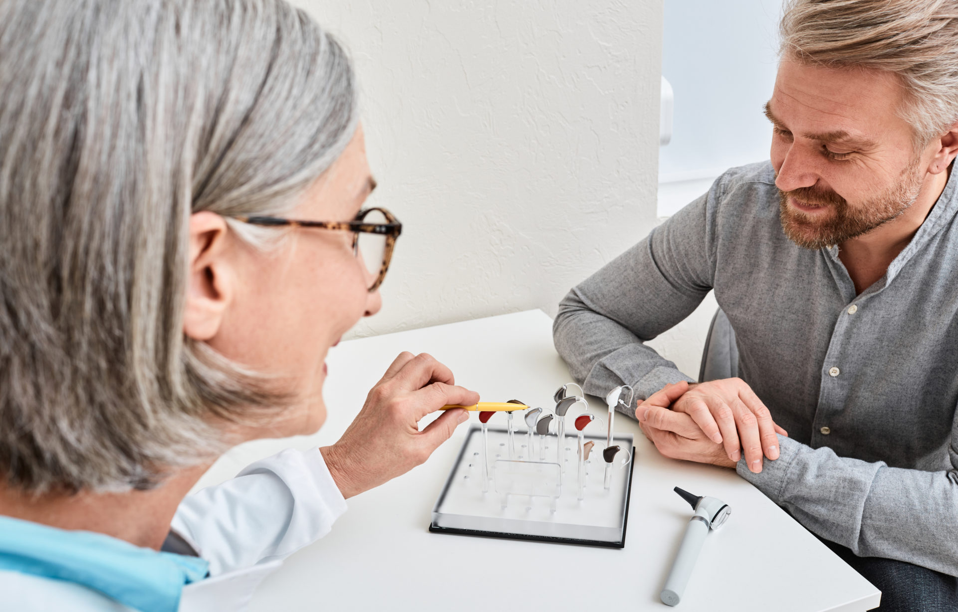 Man-choosing-hearing-aids