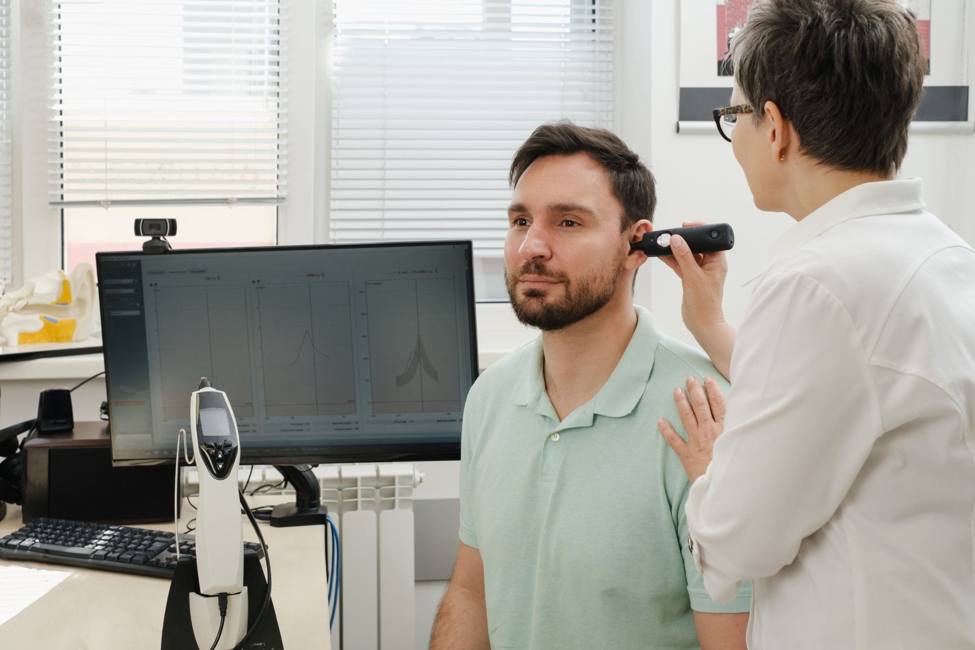 man-testing-his-hearing-with-audiologist